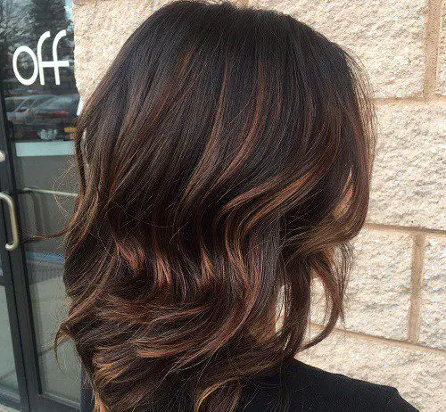 Dark brown hair with caramel highlights